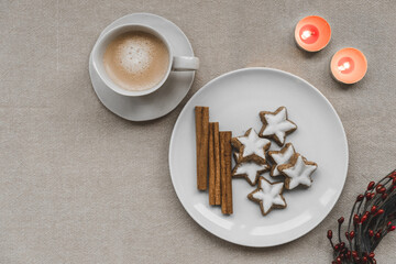 Christmas cookies for Sasnta Claus with candle and coffee