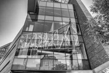 Glass building reflects queensboro bridge, Manhattan.