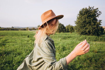 Portrait happy woman enjoying sunset stay on the green grass. Fresh air, Travel, Holidays and Journey concept. Nature banner