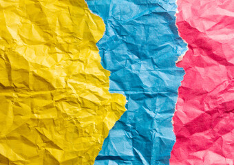 Photo of crumpled wrinkled three different colorful wrapped paper parts for background laying on each other 