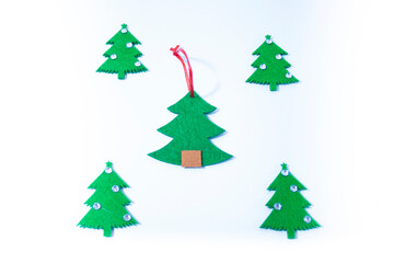 Five green felt Christmas trees on a white background