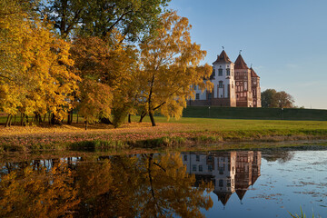 Autumn park with pond and old medieval castle in Mir township, Grodno region, Belarus.