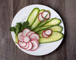 salad of sliced cucumbers and radishes with parsley