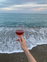 person holding a glass of red wine