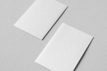 Textured business card mockup, vertical orientation. 55x85 mm.