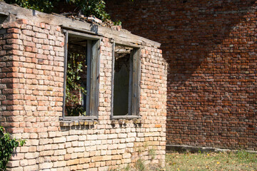Fototapeta na wymiar An old abandoned dilapidated house with brick walls