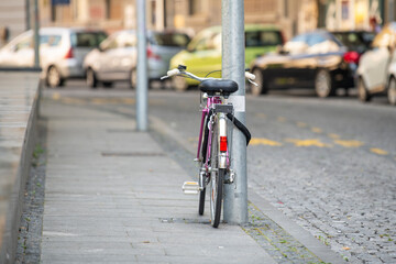 Fototapeta na wymiar bicycle tied to a pole on the street
