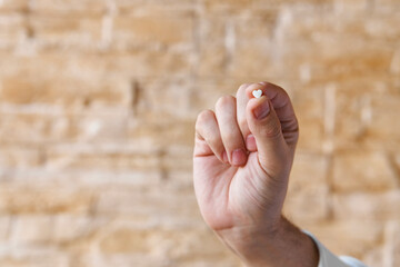 Heartache medicine. Pill in shape of heart against heart pain