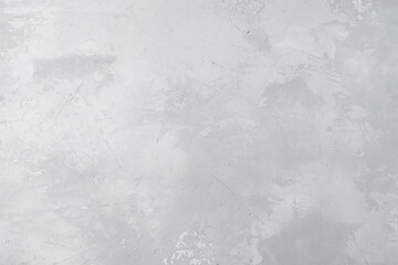 White-gray textured background for concrete. Gray streaks and cracks. Top view