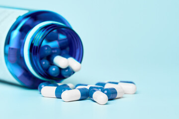 White and blue capsules on a light background