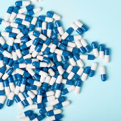 White and blue capsules on a light background