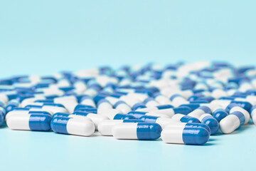 White and blue capsules on a light background