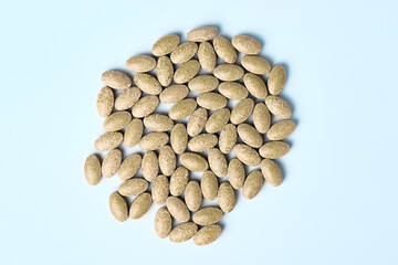 Daily vitamins on a light background. Light brown pills