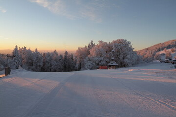 Frozen morning at moutains with first snow ski slope downhill course  dawn daybreak