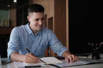 American employee working with stock trading document in home office. Business financial concept.