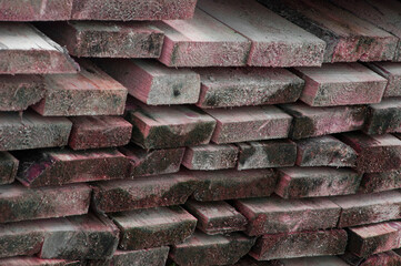 stacked chopped firewood. timber bars at a sawmill. wood background.	