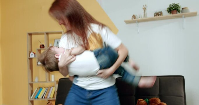 Mother playing with kids in living room