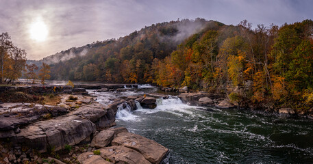 Panorama of Valley Falls State Park near Fairmont in West Virginia on a colorful misty autumn day with fall colors on the trees
