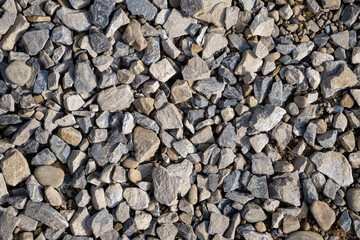 Crushed stones background on the railway. Close up stone texture, Crushed stone, railway ballast. Stones background.