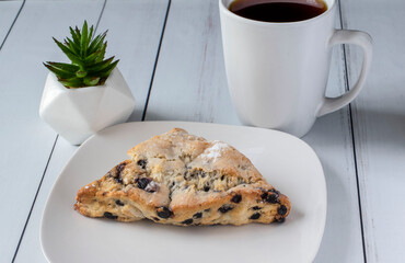 blue berry scone served with a cup of coffee