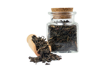 yunnan black tea in wooden scoop and glass jar on isolated on white background.