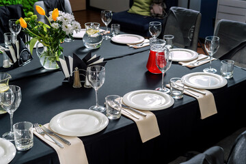 Table setting for a wedding or dinner event, black tablecloth white plates-2.