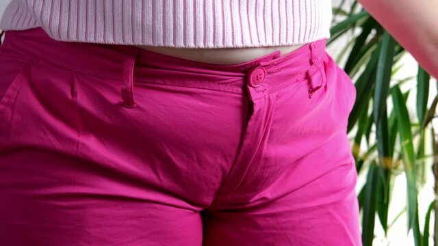 fat woman in pink sweater measures waist circumference with inch tape, belly stands, concept time to lose weight, wrong lifestyle, consequences of inactivity, unhealthy diet