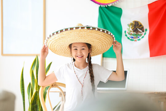 Little girl in sombrero hat at home