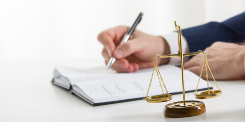 Lawyer working with contract papers and wooden gavel on tabel in courtroom. justice and law...