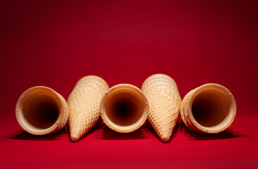 A group of  empty waffles cones on red background