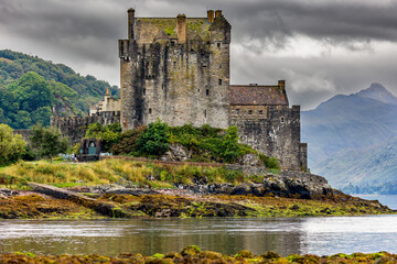 Dramatic Scottish castle with a moody sky on the shore of a sea loch (Eilean Donan, Highlands)