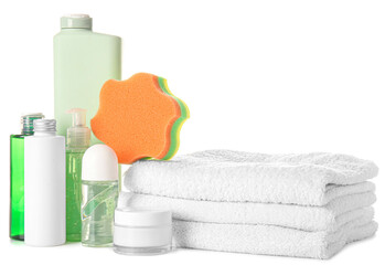 Obraz na płótnie Canvas Bottles of cosmetic products, jar with facial cream, bath sponge and stack of towels on white background