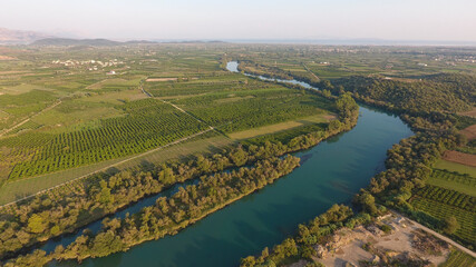 Aerial view of trees and farmland next to Acheloos river in West Greece