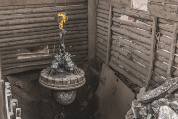 Magnetic scrap crane recycles and unloads junk and old metal in a landfill