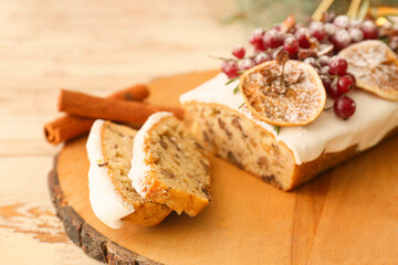 Board with tasty Christmas bread on wooden background