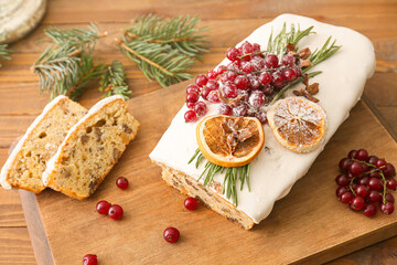 Board with tasty Christmas bread on wooden background