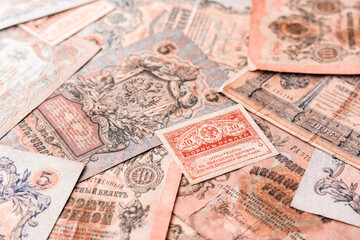Chaotically scattered old worn ruble banknotes of royal russia