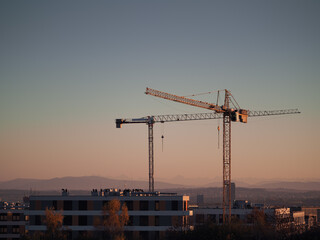 Construction crane on a construction site used for the construction of residential houses