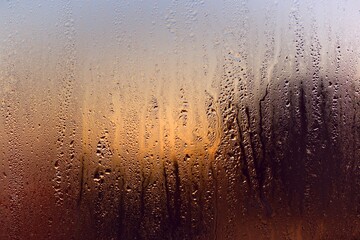 Water drops on a window, on a cold winter morning.
