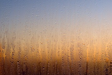 Water drops on a window, on a cold winter morning.