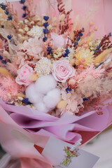 Bouquet dried flower arrangement in pink, yellow and purple. Striking flowers arrangement, comes beautifully wrapped for gift-giving.