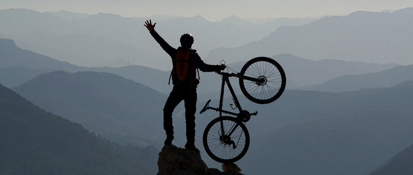silhouette of a person on a mountain bike