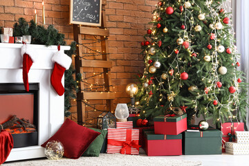 Christmas tree with presents near brick wall