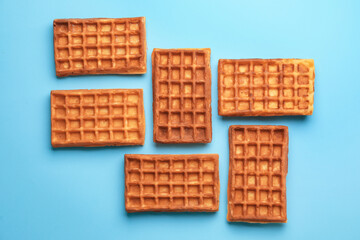 Delicious Belgian waffles on color background