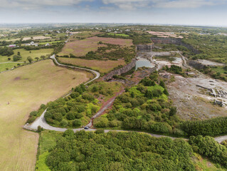 Aerial view on old abandoned quarry. Cloudy sky. Industrial impact on environment concept. County Galway, Ireland. Rural landscape.