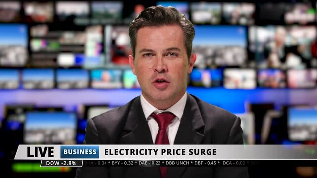 Male television anchor at news desk presenting business news, economic crisis, inflation, energy crisis