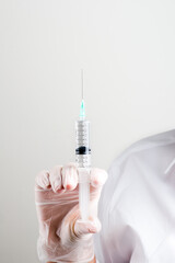 hand in glove holds a syringe. Doctor holds a syringe for vaccination.