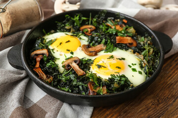 Frying pan with tasty Shakshouka on wooden background