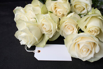 bouquet of white roses and a card for congratulations