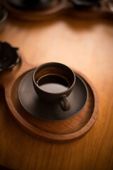 Obraz na płótnie Canvas Cup of black coffee on a wooden table